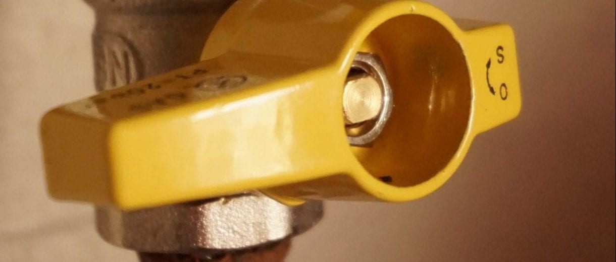 Student Services - Close-up of a yellow pipe valve.