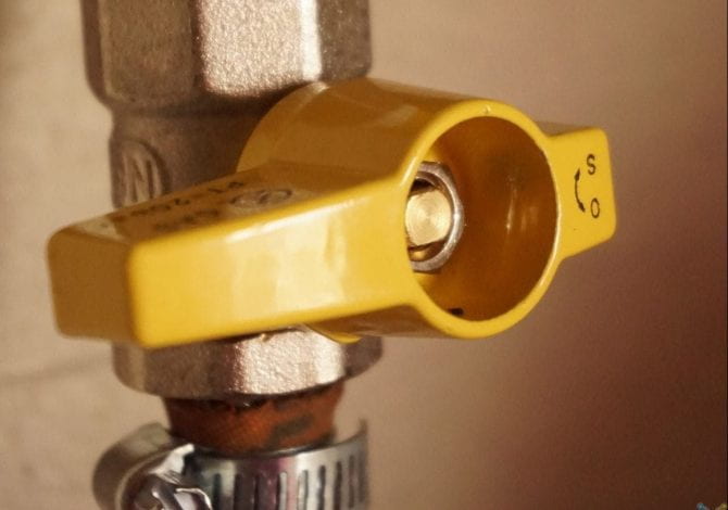 Student Services - Close-up of a yellow pipe valve.
