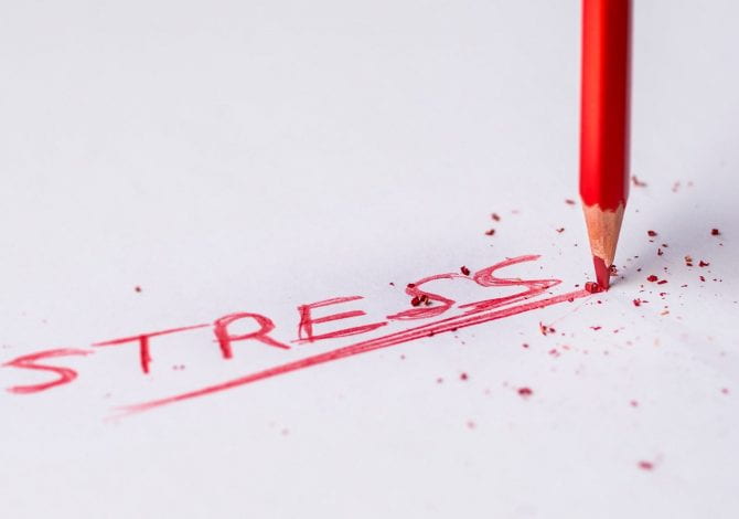Student Services - Close up of a red pencil underlining the word stress.